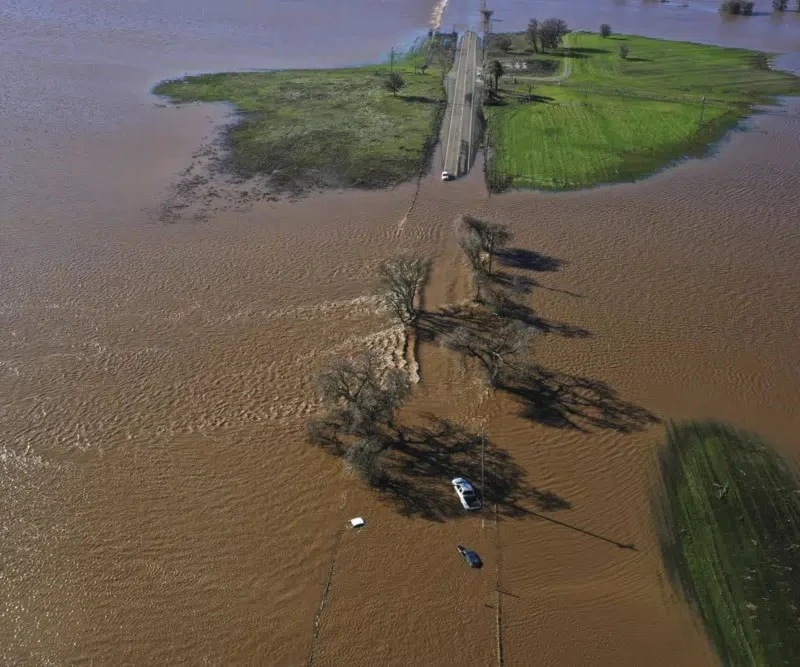 Three vehicles are submerged on Dillard Road west of Highway 99 in south Sacramento County in Wilton, Calif., Sunday, Jan. 1, 2023. (AP) Three vehicles are submerged on Dillard Road west of Highway 99 in south Sacramento County in Wilton, Calif., Sunday, Jan. 1, 2023. (AP)