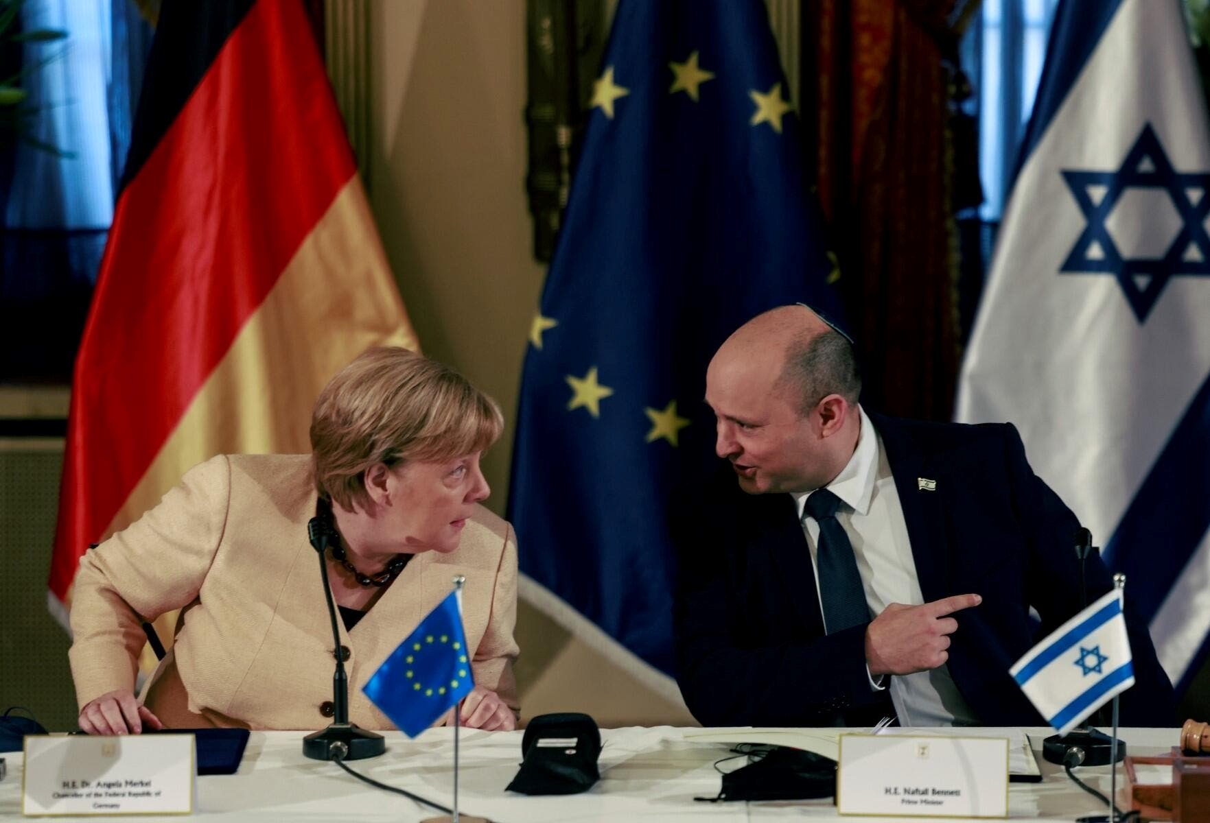 German Chancellor Angela Merkel attends a cabinet meeting with Israeli Prime Minister Naftali Benett in occupied Al-Quds, on October 10, 2021 | AFP