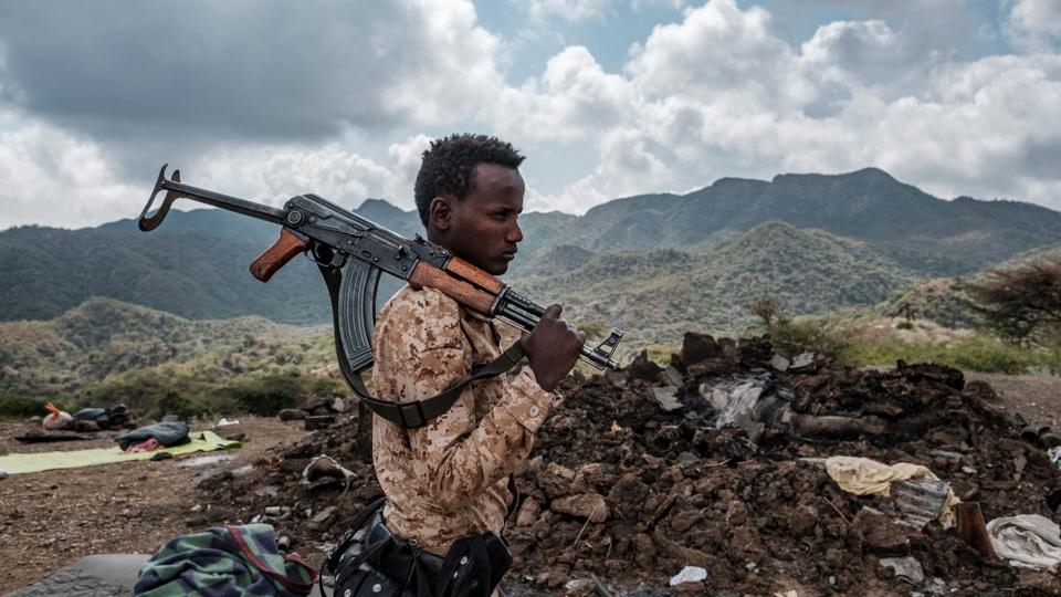 member of the Afar Special Forces stands in front of the debris of a house in the outskirts of the village of Bisober, Tigray Region, Ethiopia., on December 09, 2020 (Credit: AFP)