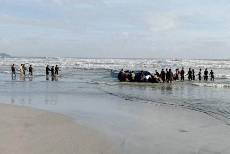 People search Tanjung Balau beach after a boat carrying migrants capsized on Wednesday. (Royal Malaysian Army/Handout via REUTERS)