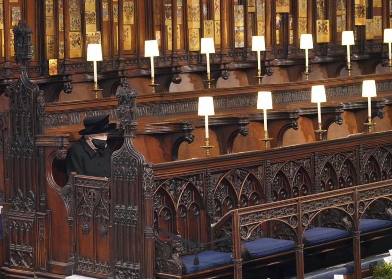 Queen Elizabeth sits alone in church during her husband's funeral