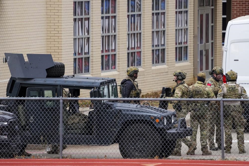 Law enforcement teams stage near Congregation Beth 