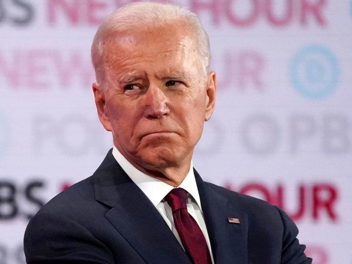 Joe Biden listens to rivals during the sixth Democratic presidential candidates debate, in Los Angeles on 19 December (Reuters)