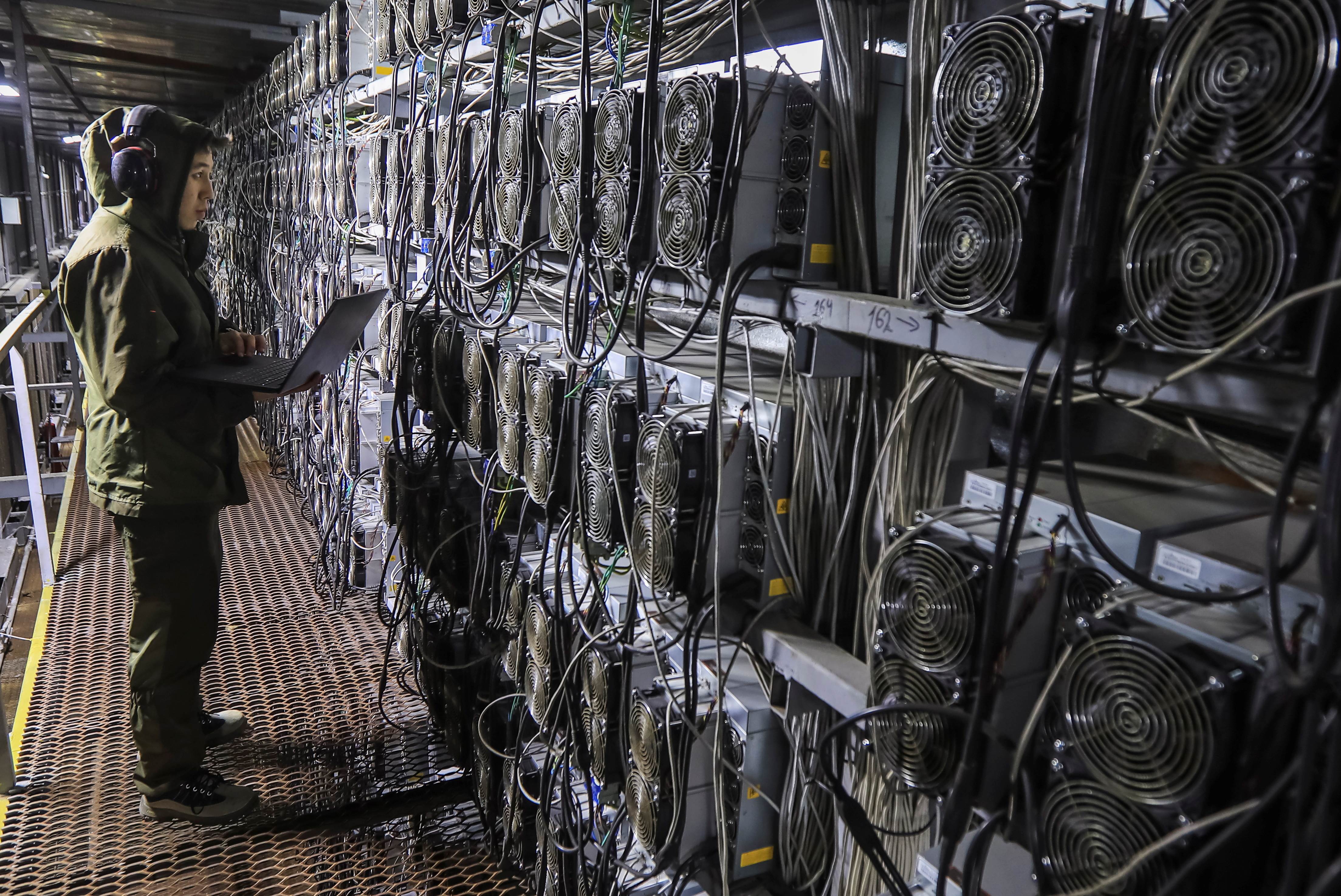 A maintenance specialist works inside the data center of the BTC KZ crypto mining company located near the coal-fired thermal power plant outside the town of Ekibastuz, Kazakhstan November 7, 2021 (REUTERS/Pavel Mikheyev)