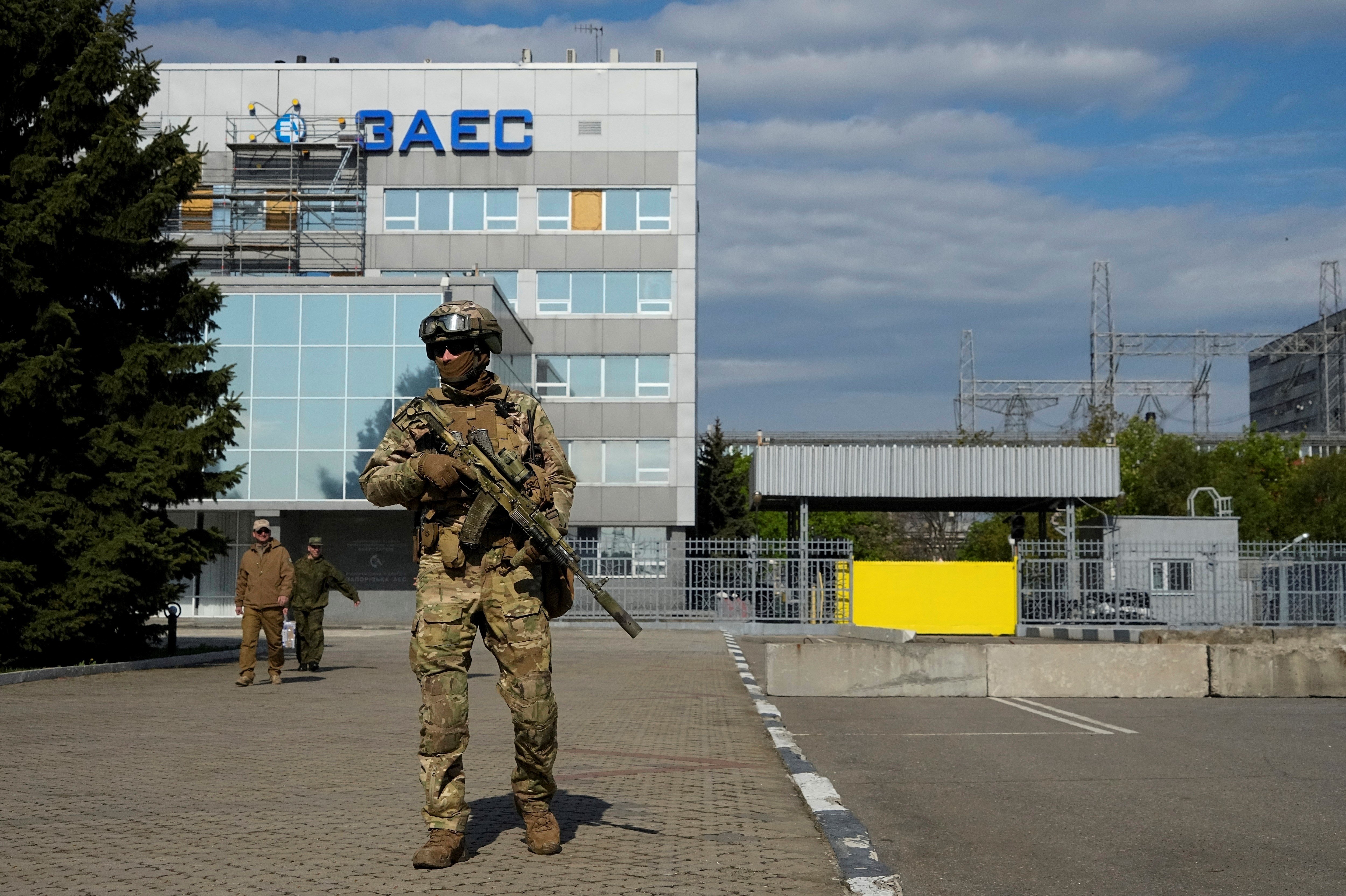 A Russian serviceman stands guard in an area of the Zaporozhye Nuclear Power Station, on May 1, 2022 (AP Photo, File)