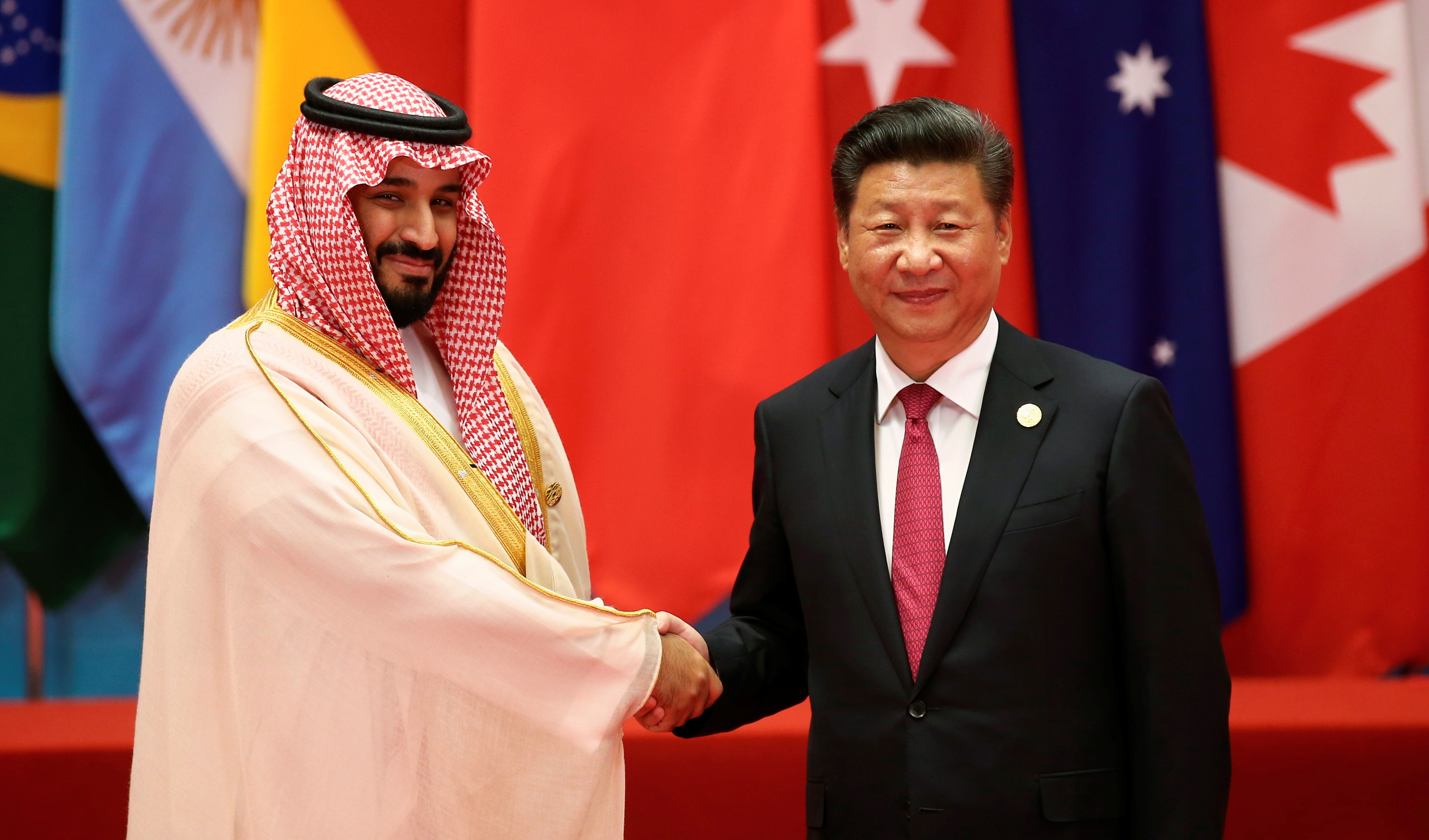 Chinese President Xi Jinping shakes hands with Saudi Arabia's Mohammed bin Salman (Reuters)