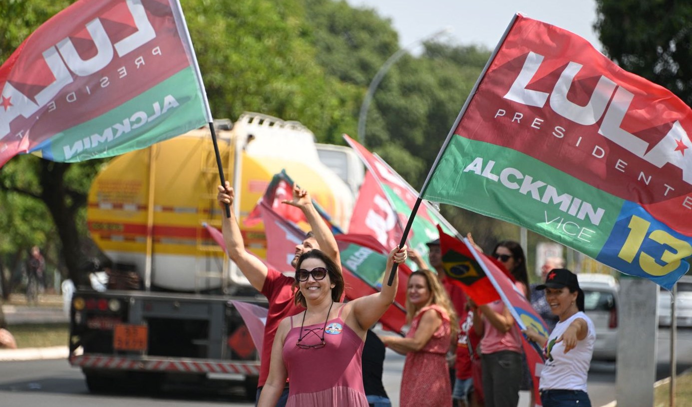 Supporters of Brazilian presidential candidate Luiz Inácio Lula da Silva wave the candidate’s flag on a street in Brasília, the Brazilian capital, on October 22. Source: Evaristo Sa/AFP via Getty Images.