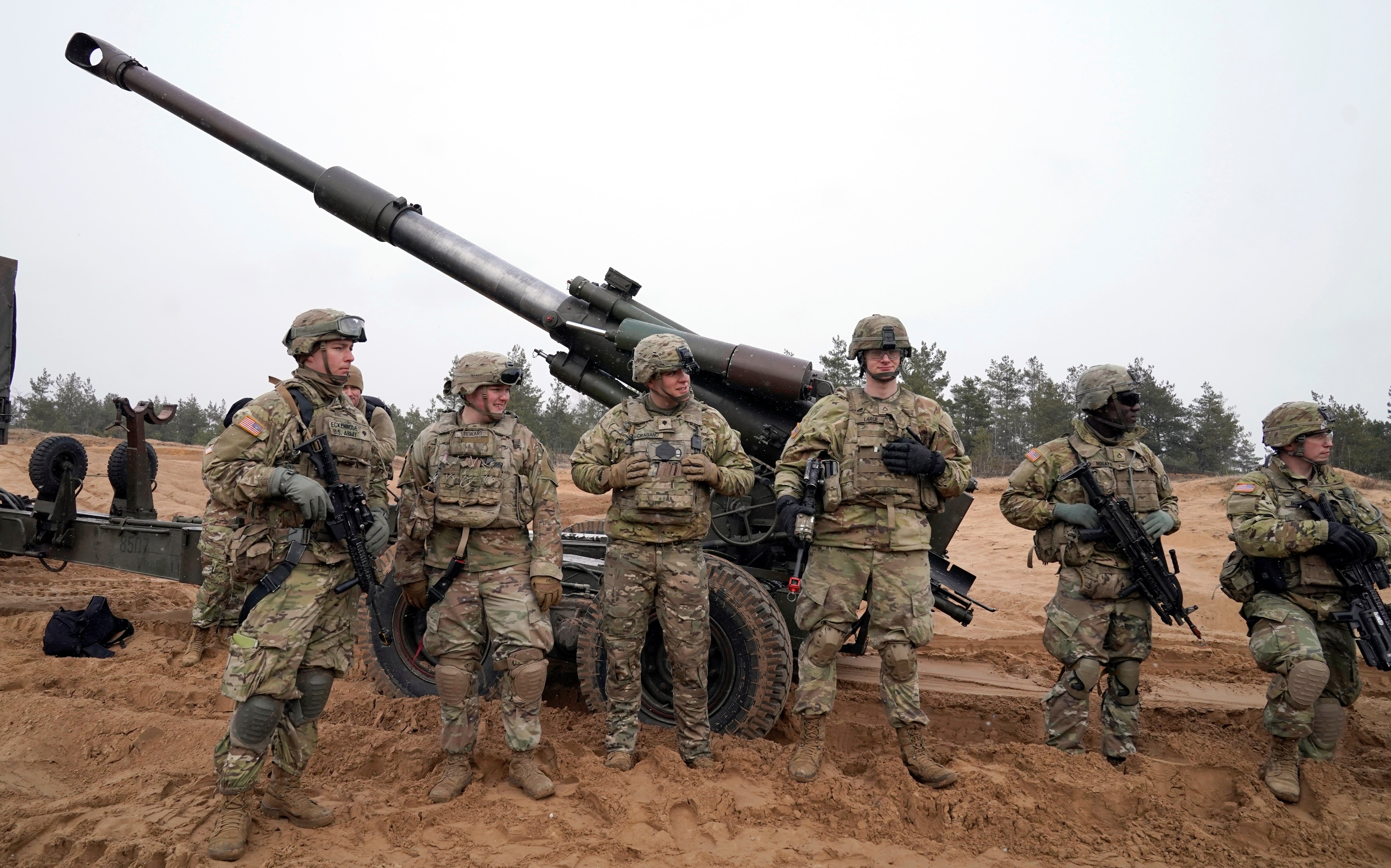 U.S. troops stand during military drills at Adazi Military base in Kadaga, Latvia, Tuesday, March. 8, 2022 (AP Photo/Roman Koksarov)