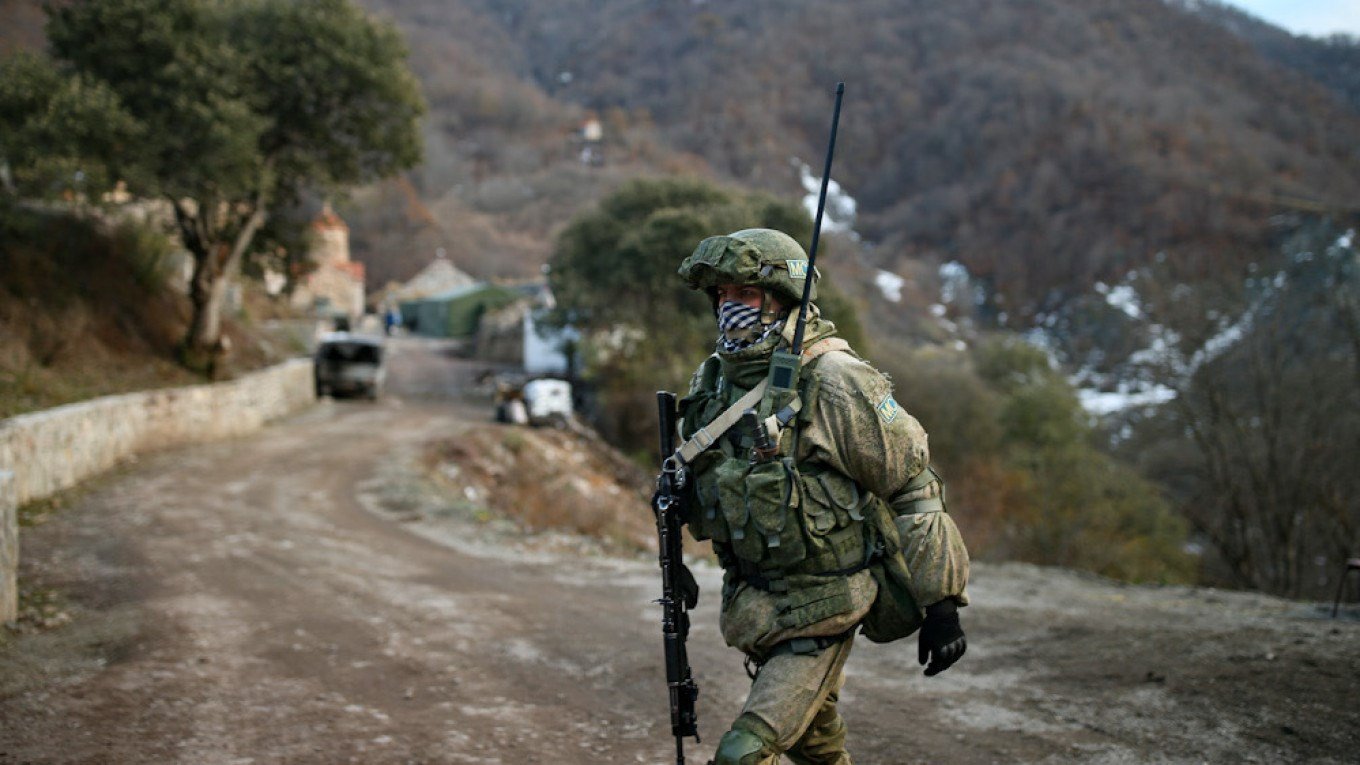 A Russian peacekeeper guards an entry of the Dadivank, an Armenian Apostolic Church monastery near Kalbajar, Azerbaijan, on December 2, 2020. (AFP)