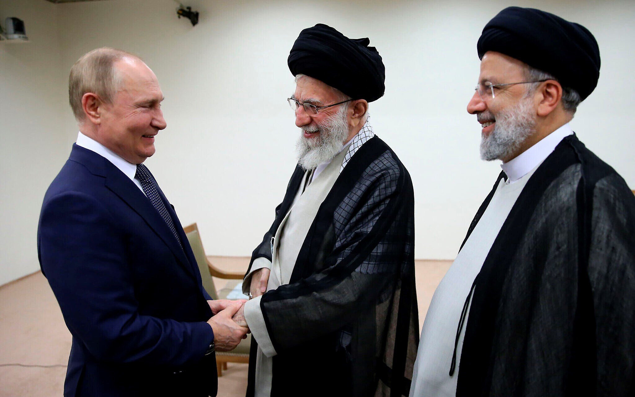 Iranian Leader Ayatollah Ali Khamenei, center, and Russian President Vladimir Putin, left, greet each other as Iranian President Ebrahim Raisi stands at right, during their meeting in Tehran, Iran, July 19, 2022 (Office of the Iranian Leader via AP)