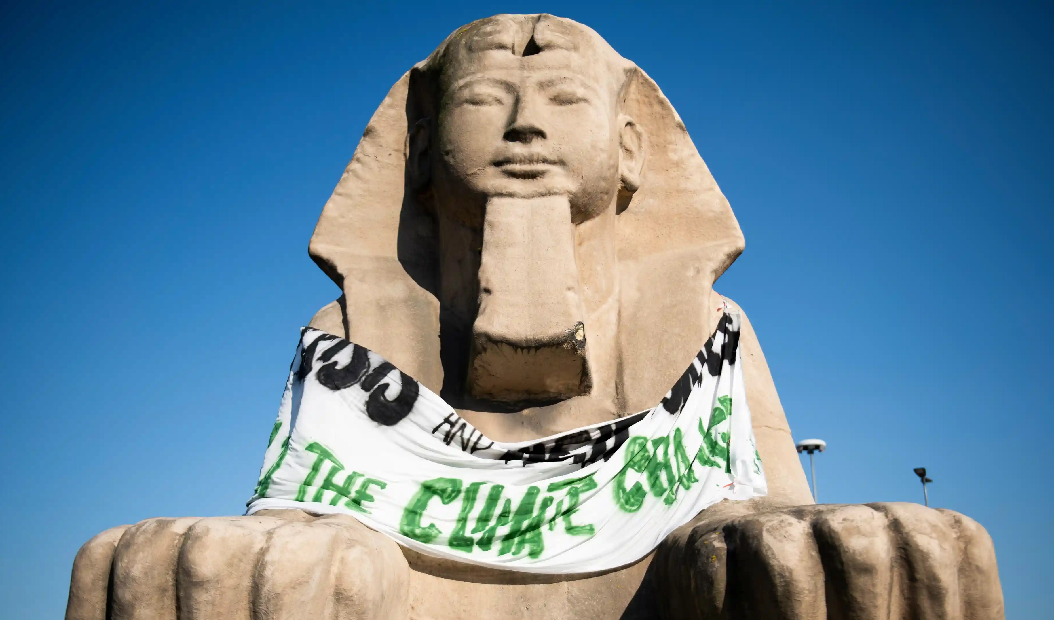 Activists hang protest banner on the Sphinx outside the Egyptian Museum in Italy. Source: Stefano Guidi/ Getty Images