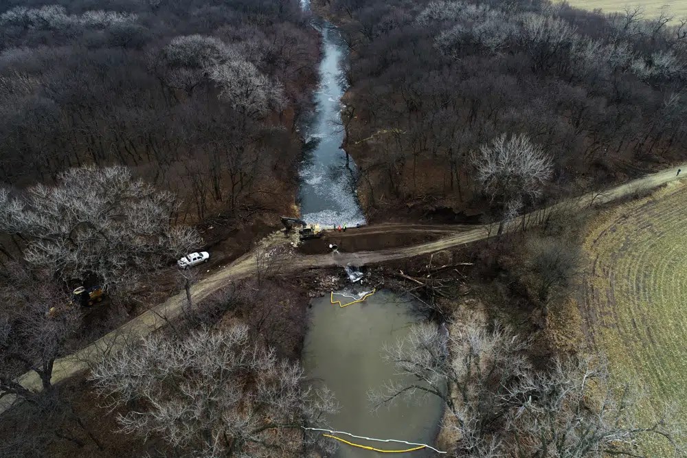 In this photo taken by a drone, cleanup continues in the area where the ruptured Keystone pipeline dumped oil into a creek in Washington County, Kan., Friday, Dec. 9, 2022. Source: DroneBase via AP.