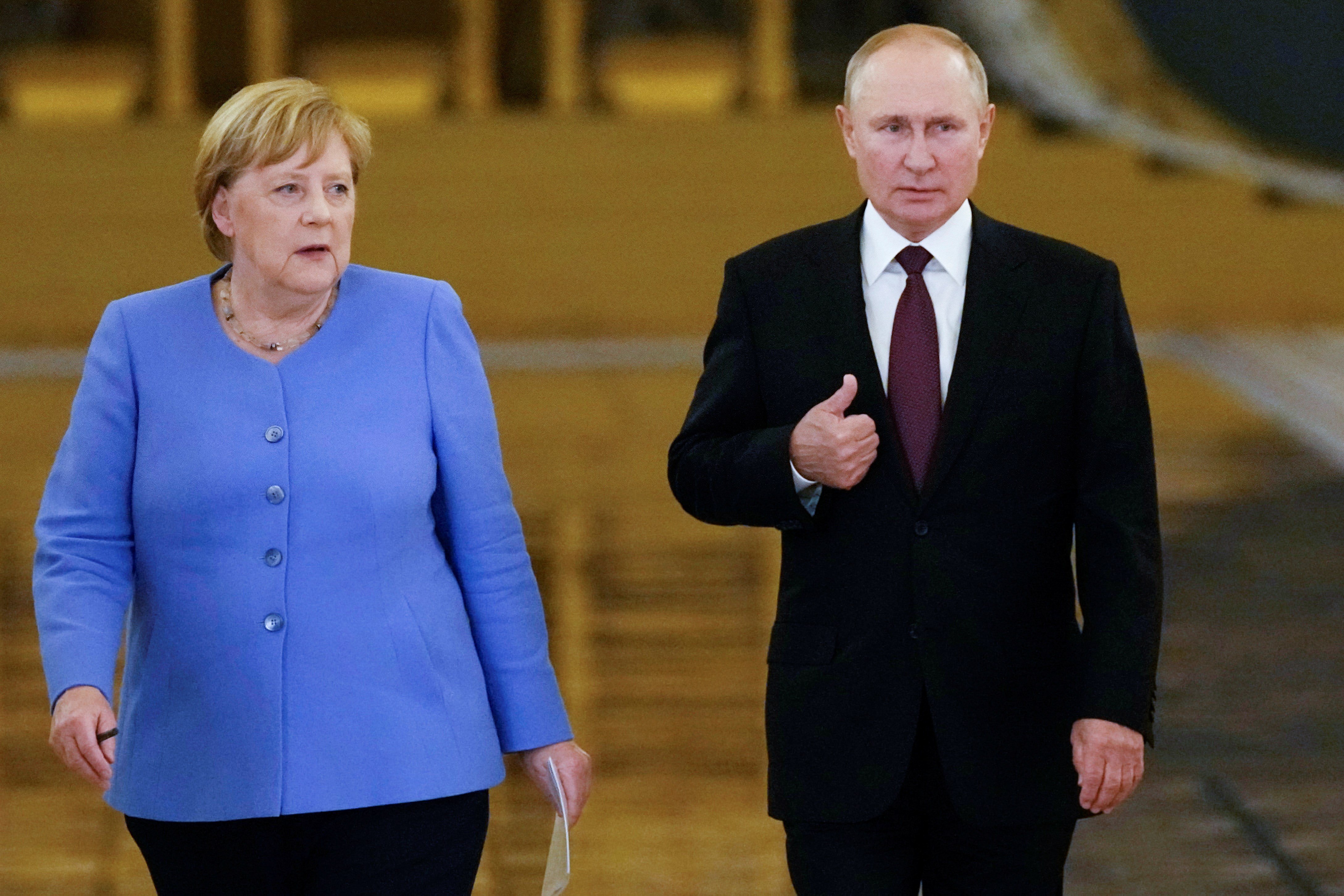 Russian President Vladimir Putin and former German chancellor Angela Merkel (Getty Images)