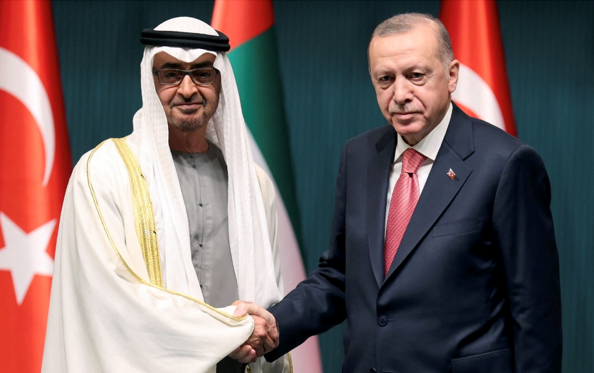 Turkish President Recep Tayyip Erdogan shakes hands with Abu Dhabi's Crown Prince Sheikh Mohammed bin Zayed Al-Nahyan in Turkey