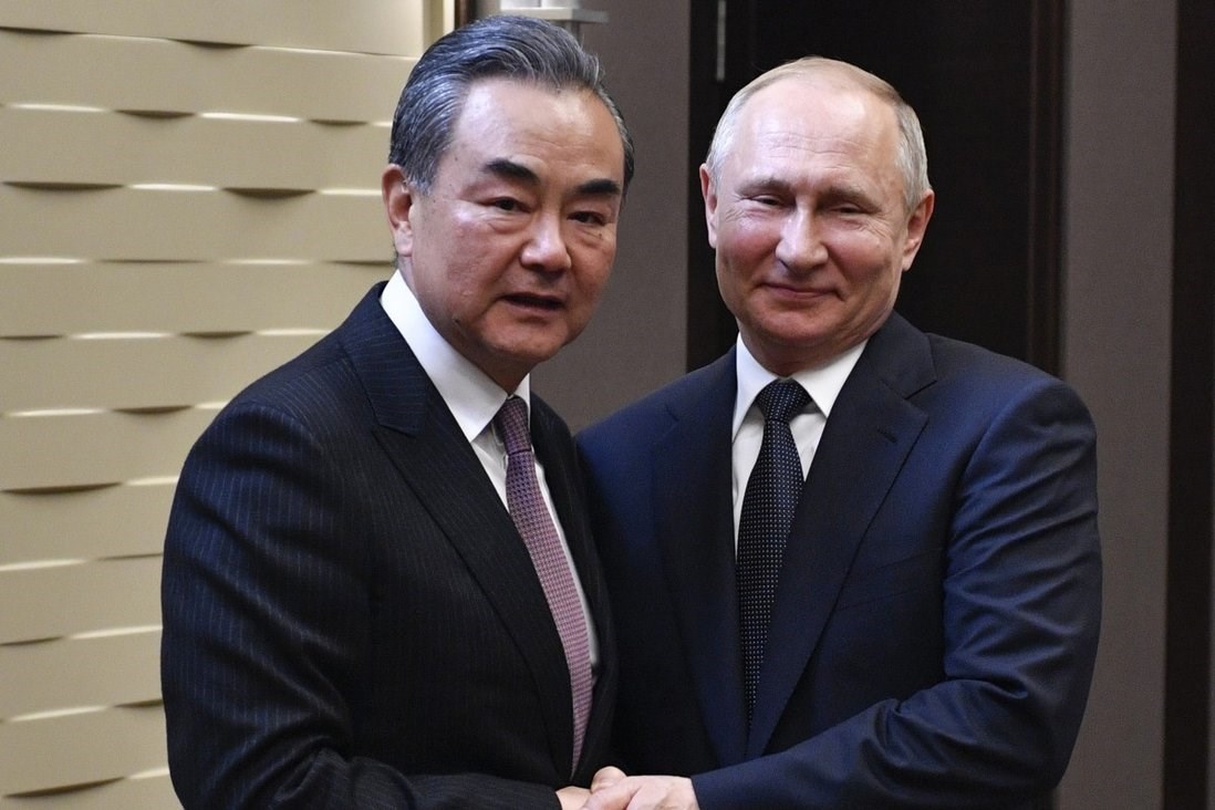 China's Foreign Minister, Wang Yi, meeting Russian President Vladimir Putin in 2019 (AP)