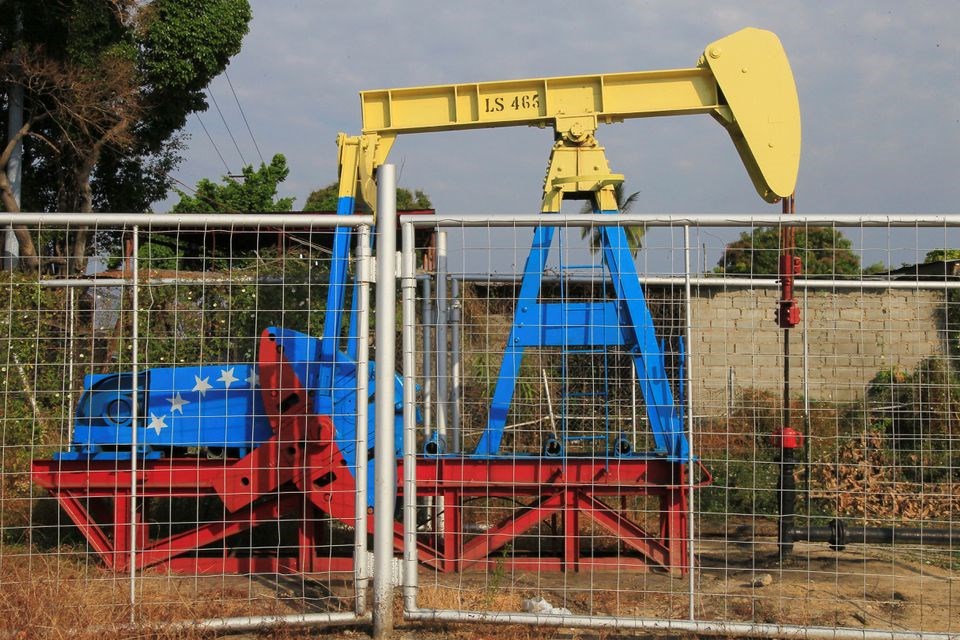 an oil pumpjack painted with the colors of the Venezuelan flag is seen in Lagunillas, Venezuela