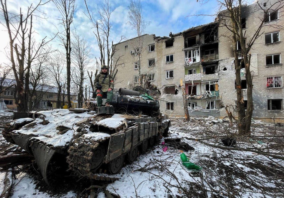 A Donbass republics' soldier standing over an abandoned Ukranian T-64 BV tank