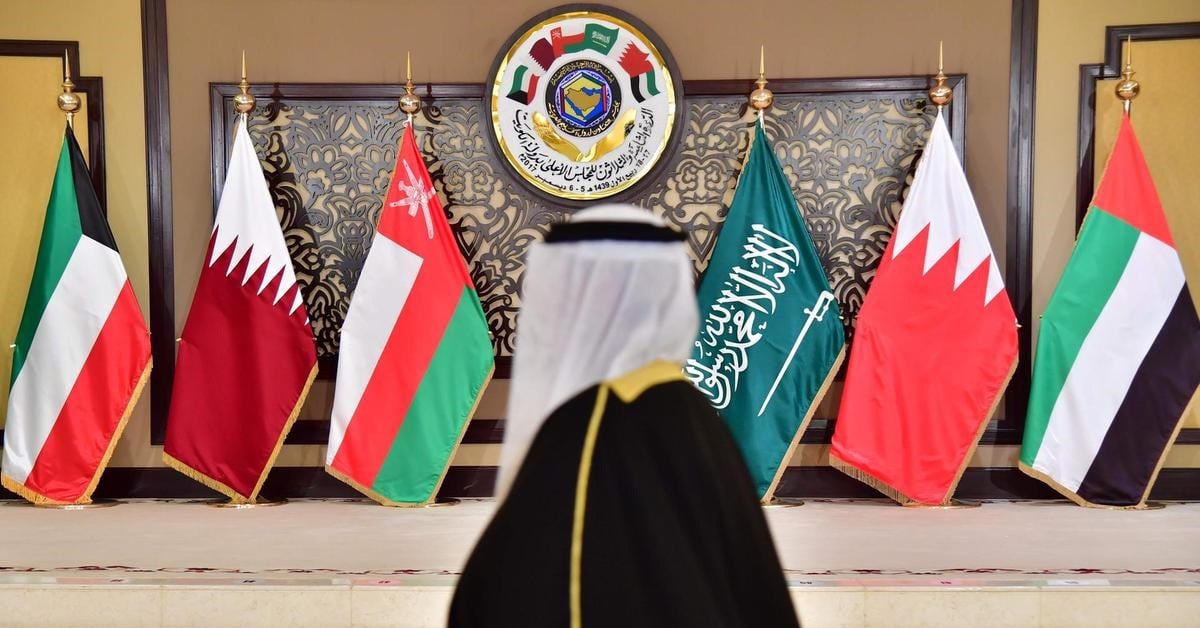 A man walks past the flags of the countries attending the Gulf Cooperation Council (GCC) summit at Bayan palace in Kuwait City on December 5, 2017. (Getty Images)