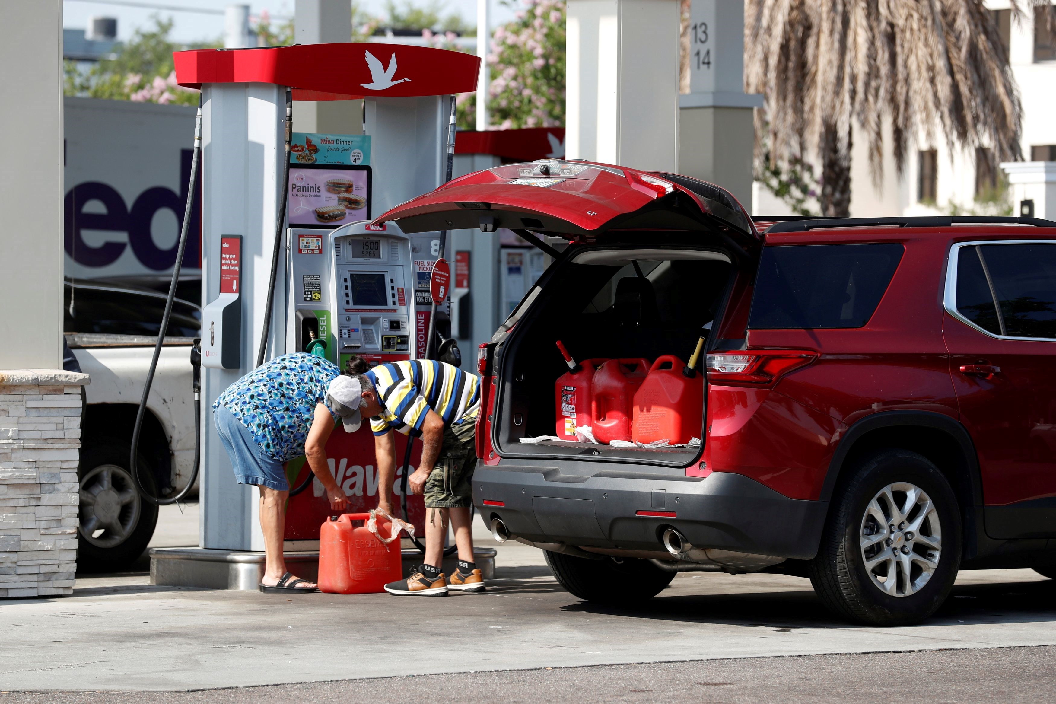 A couple filling gas containers in amid a US gas crisis Tampa, Florida