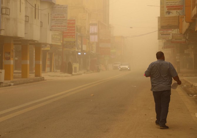 A man walks in a street during a dust storm in Iraq’s city of Nasiriyah in the southern Dhi Qar province, on Saturday. (AFP)