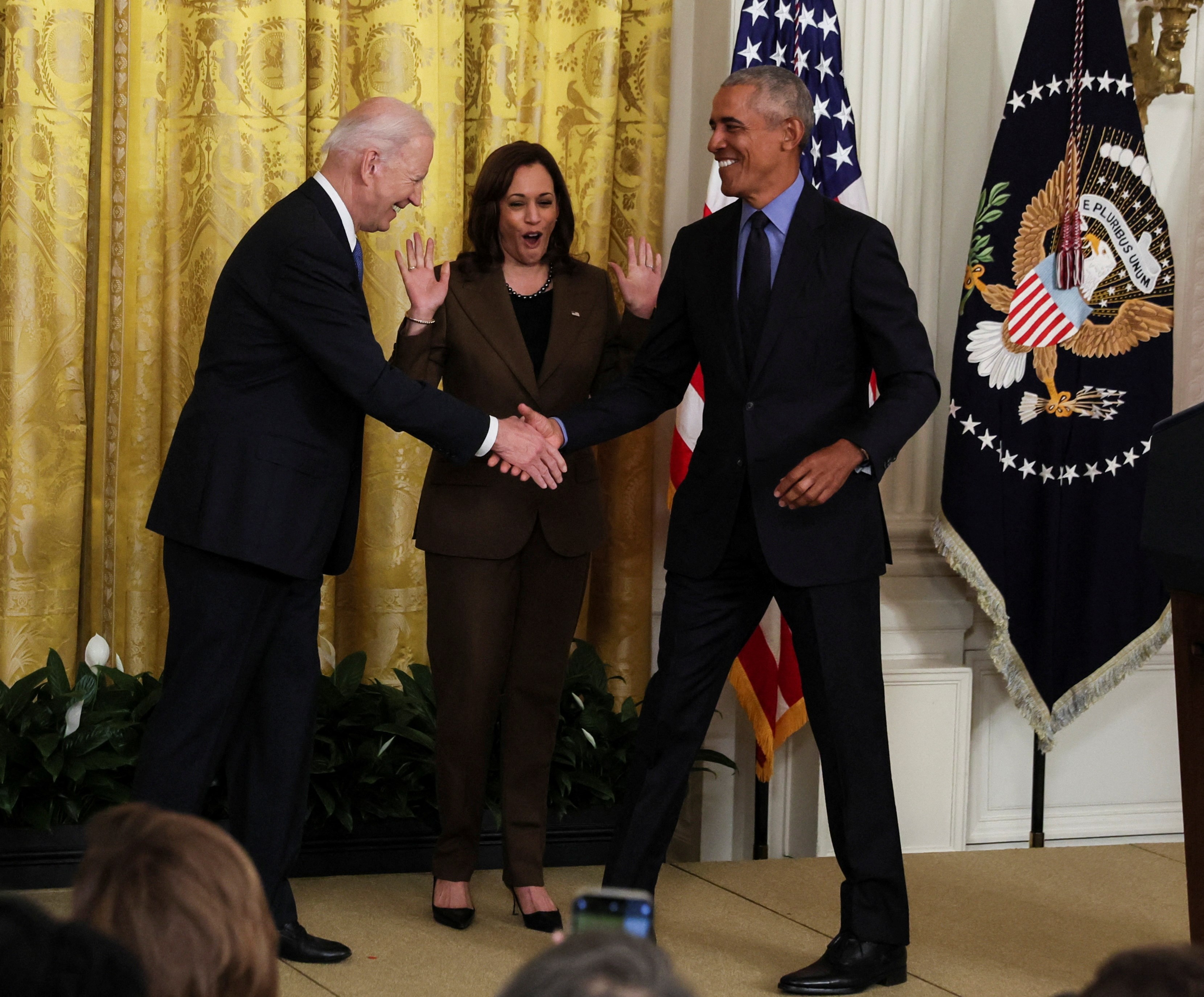 US President Joe Biden greets former President Barack Obama during an event on the Affordable Care Act, with Vice President Kamala Harris in the East Room at the White House in Washington, US, April 5, 2022 (Reuters)