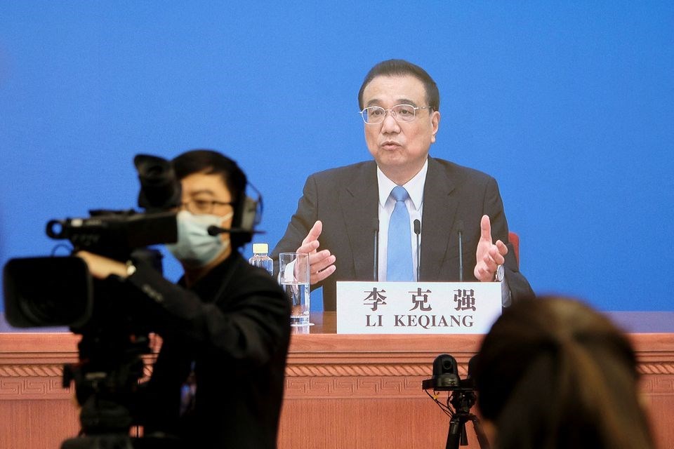 Chinese Premier Li Keqiang is seen on a screen as he attends a news conference in Beijing, China March 11, 2022. (REUTERS)