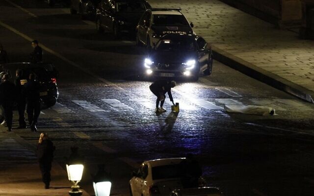 Police investigating site where two people were shot by police in Paris on April 25, 2022 (AFP)