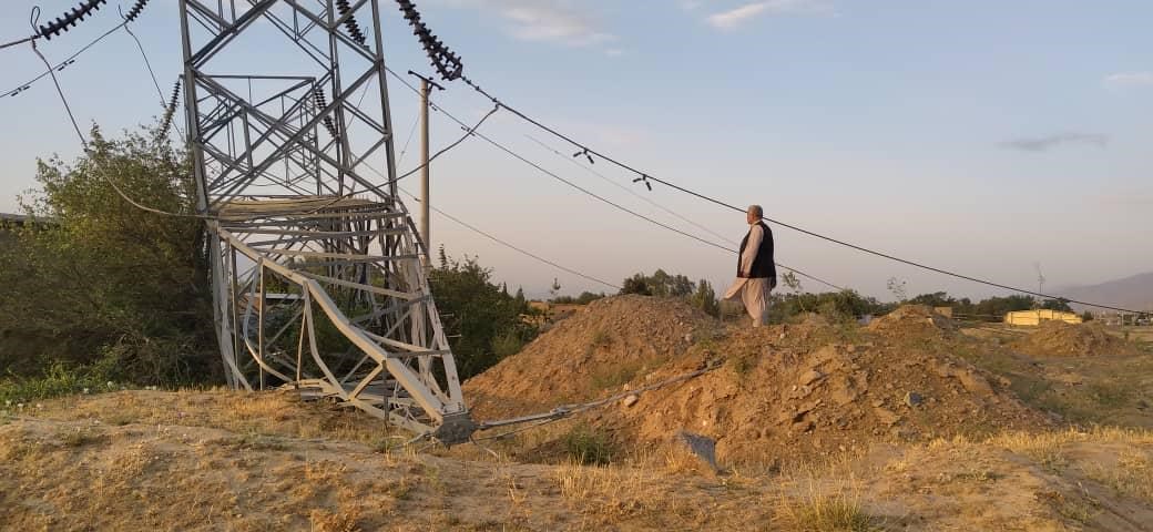 A man stands by a damaged electricity line in Parwan.