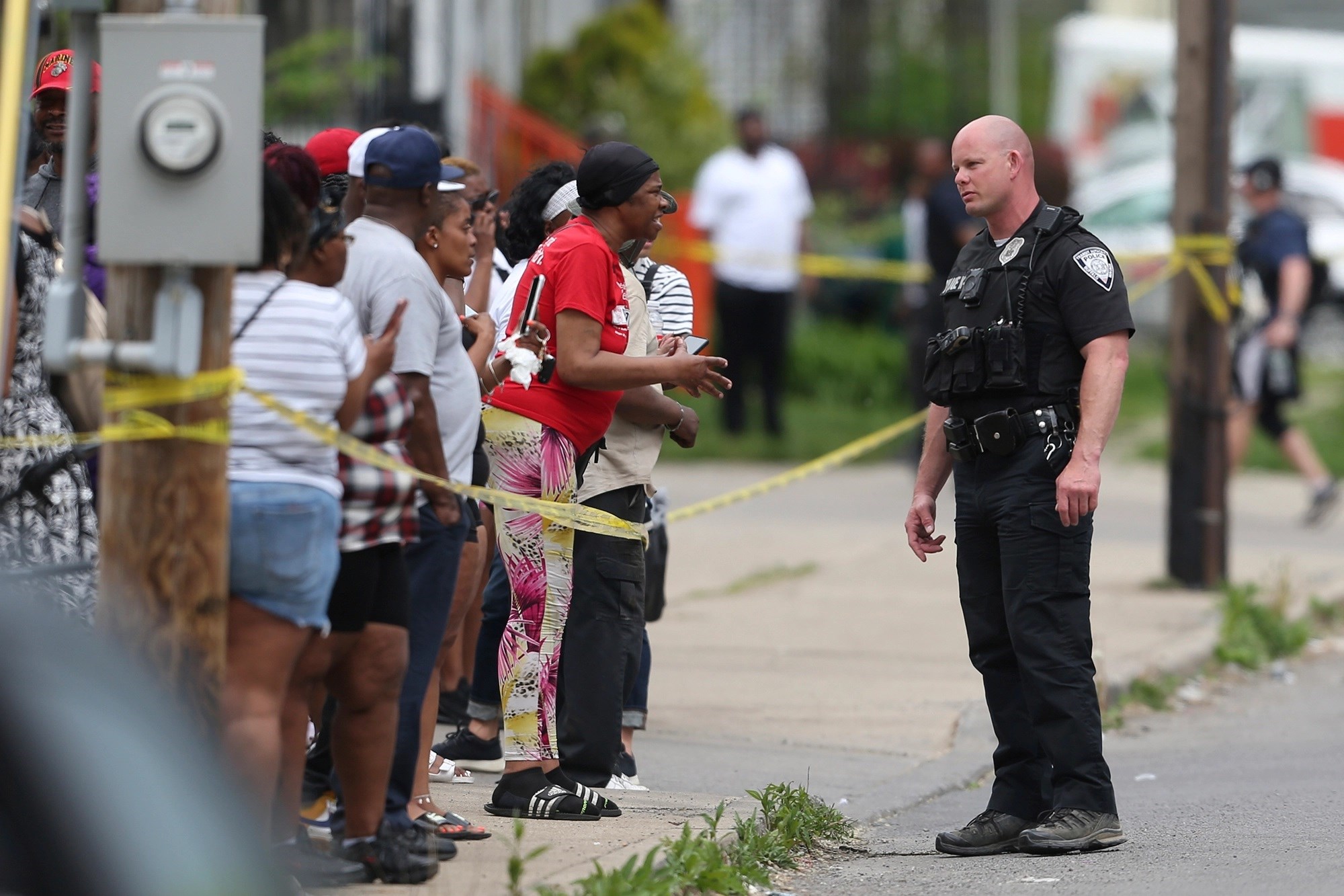 An officer speaks to distressed bystanders near the scene of the mass shooting in Buffalo, New York, United States on May 14, 2022 (AP)