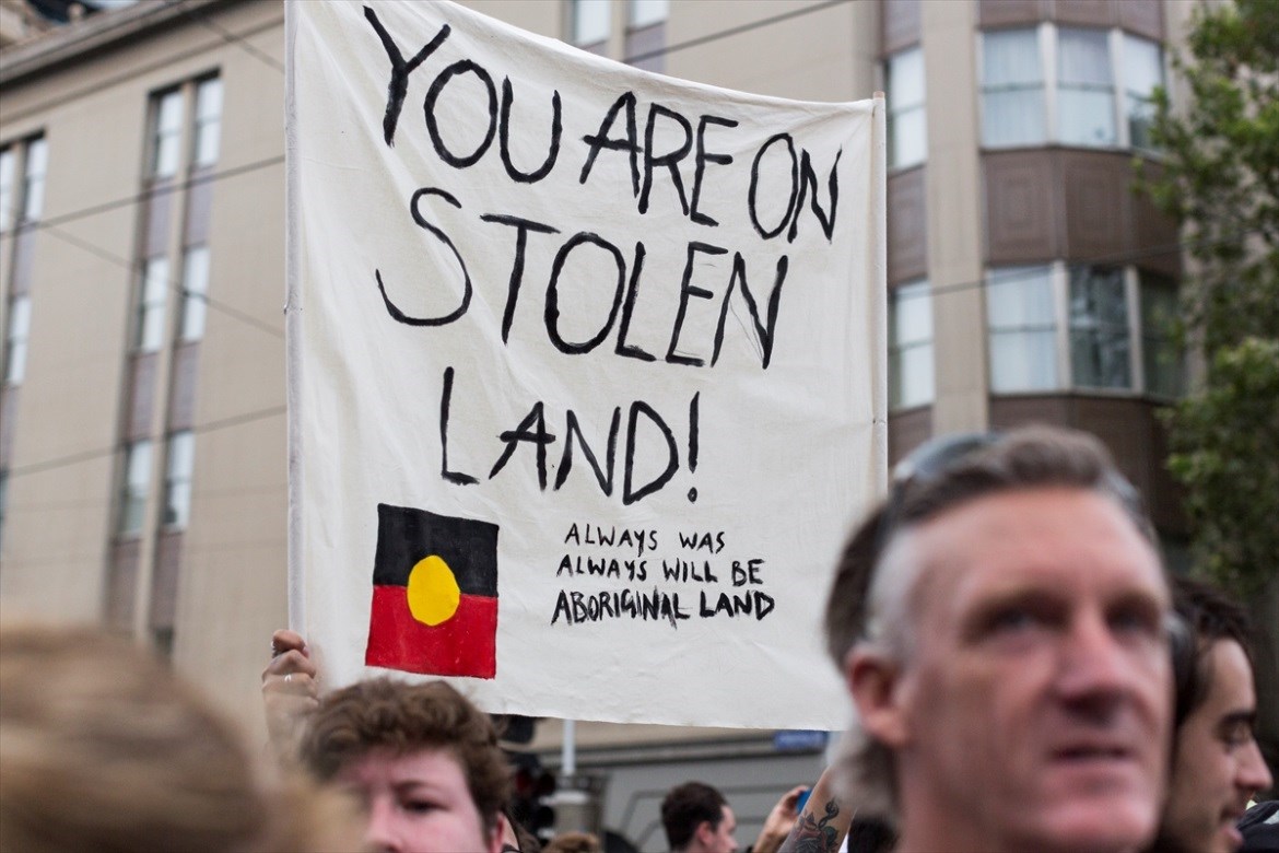Protesters hold placards during a protest organised by Aboriginal rights activists on Australia Day in Melbourne, Australia (Anadolu Agency)