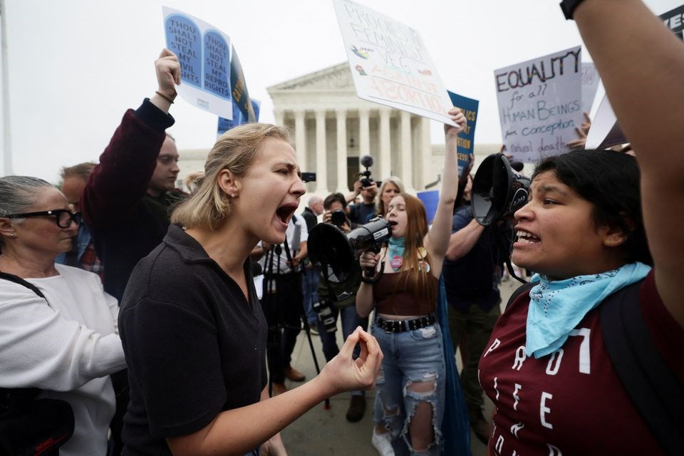Pro-abortion and anti-abortion demonstrators protest outside the US Supreme Court after the leak of a draft majority opinion to overturn the landmark Roe v. Wade in Washington, US, May 3, 2022 (Reuters)