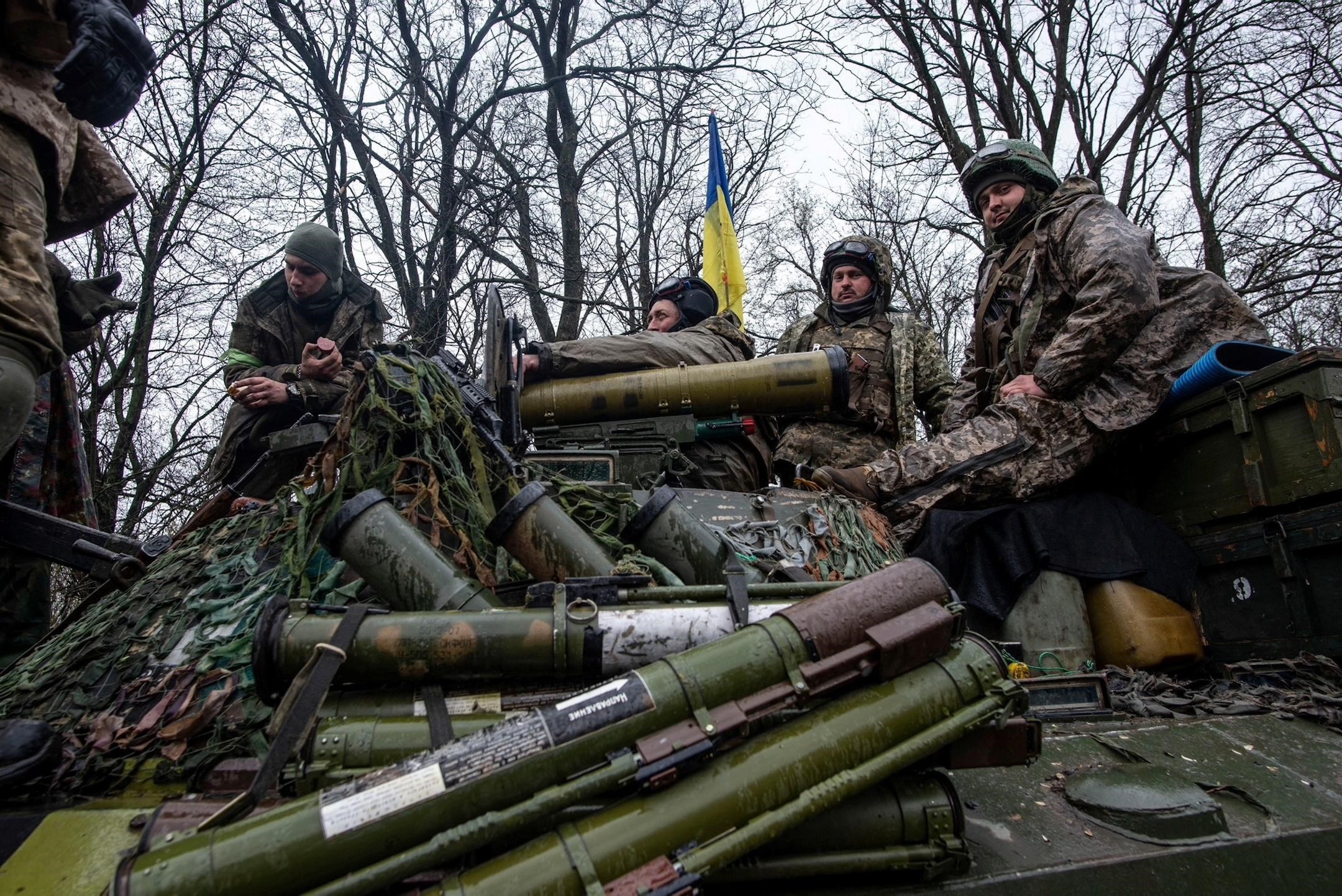 Ukrainian servicemen sit atop a tank in Donbass (Reuters)