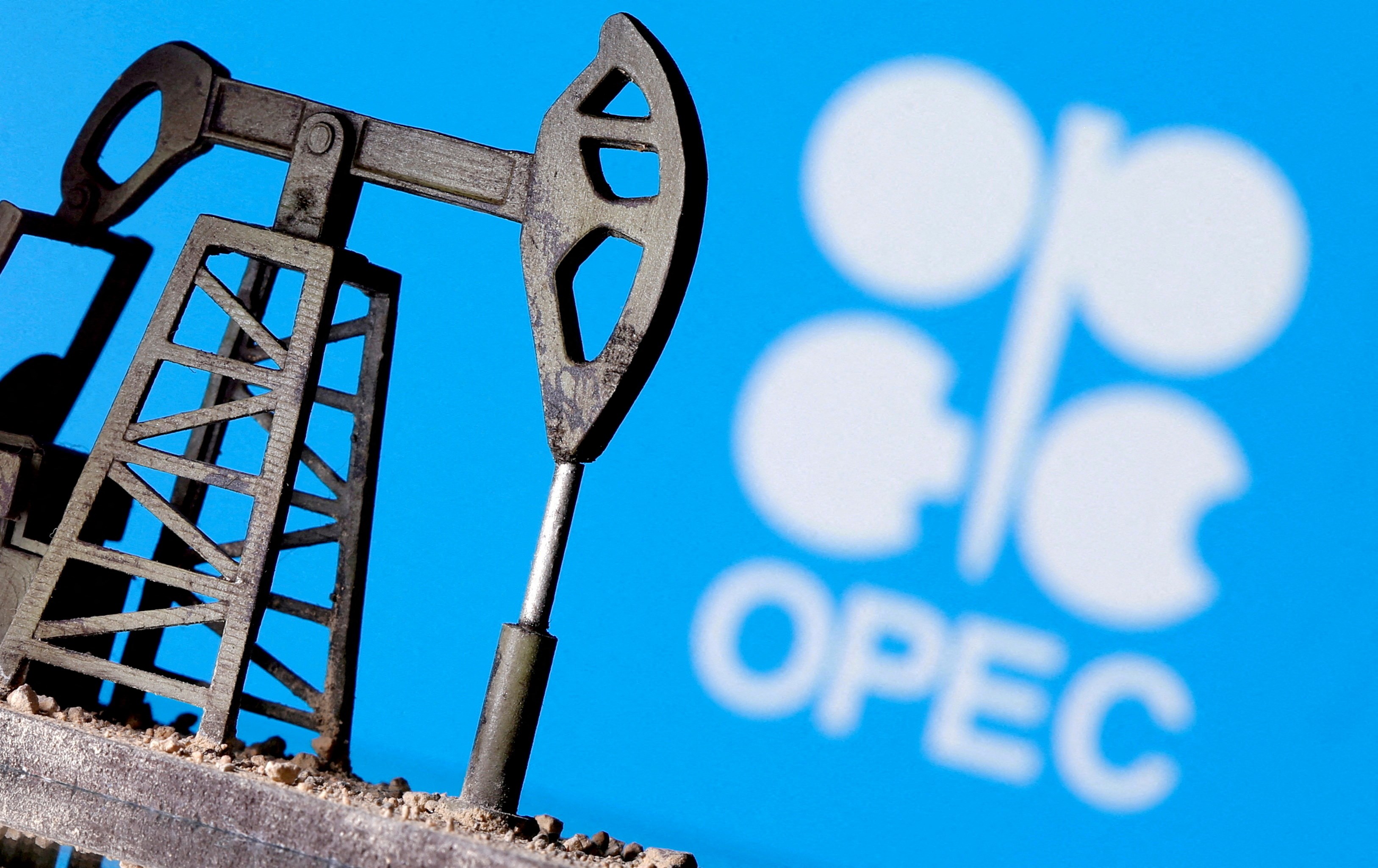A 3D-printed oil pump jack is seen in front of displayed OPEC logo in this illustration picture, April 14, 2020 (Reuters)
