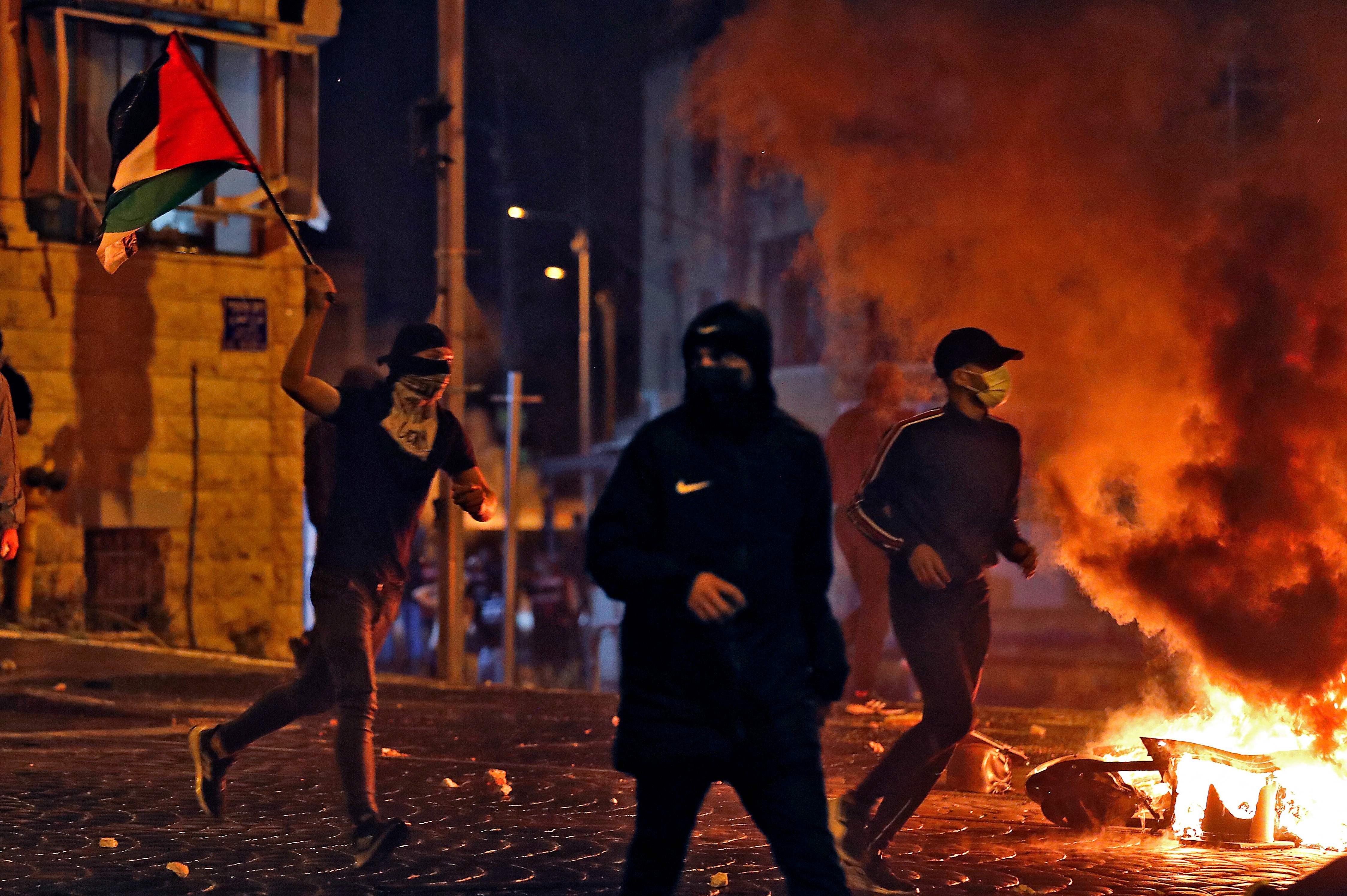 Palestinian protesters during confrontations with the Israeli occupation forces in occupied Al-Quds, occupied Palestine