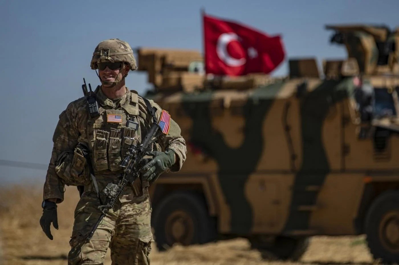 A US soldier stands guard during a joint patrol with Turkish troops in the Syrian village of al-Hashisha on the outskirts of Tal Abyad on 8 September, 2019 (AFP)