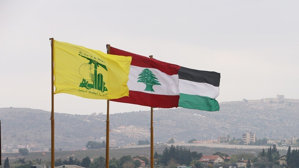 The Hezbollah, Lebanese, and Palestinian flags waving