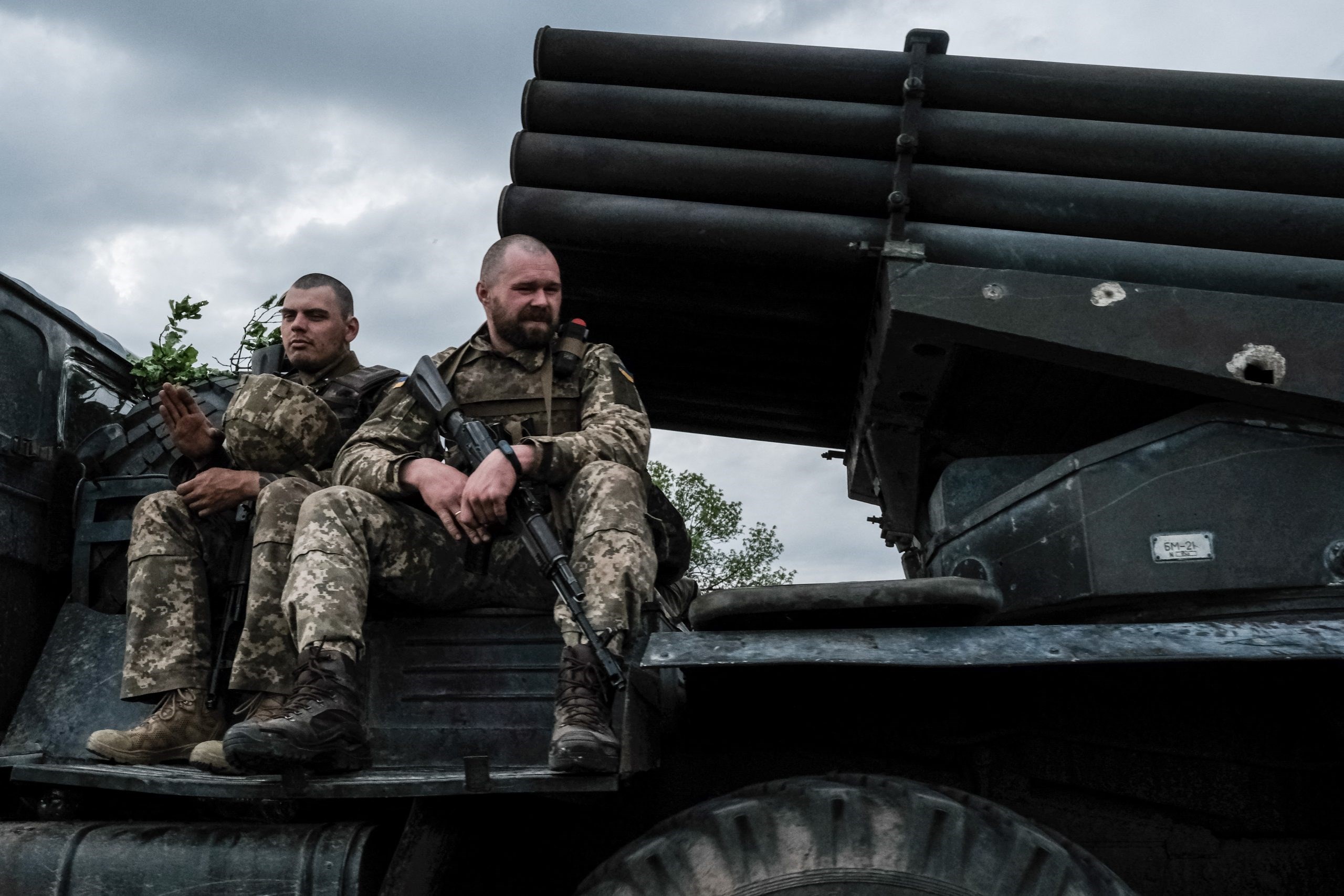 Ukrainian soldiers ride on a moving truck-mounted multiple rocket launcher near Lisichansk on May 13, 2022