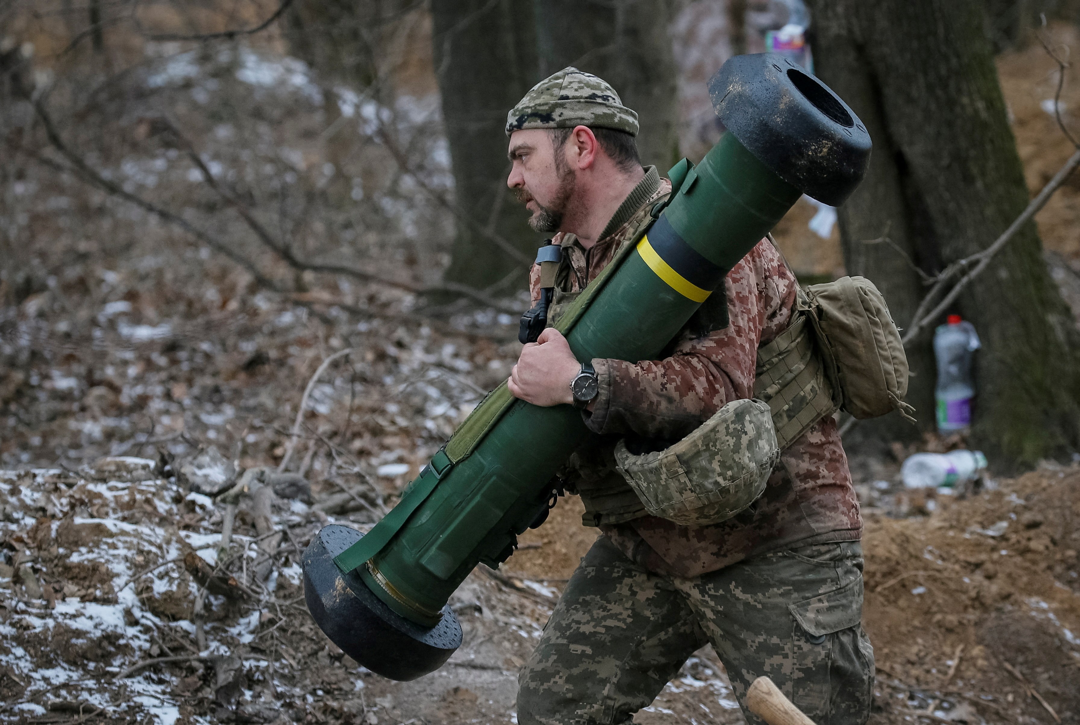 A Ukrainian soldier holds a Javelin missile system at a position in the north Kiev region, Ukraine March 13, 2022 (Reuters)