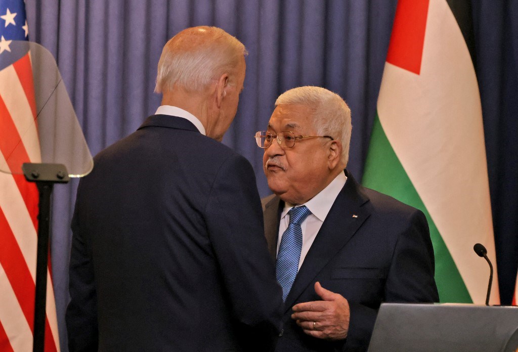 US President Joe Biden and Palestinian President Mahmoud Abbas speak together after their statements to the media at the Muqataa Presidential Compound in Beit Lahm, occupied West Bank, occupied Palestine, July 15, 2022 (AFP)