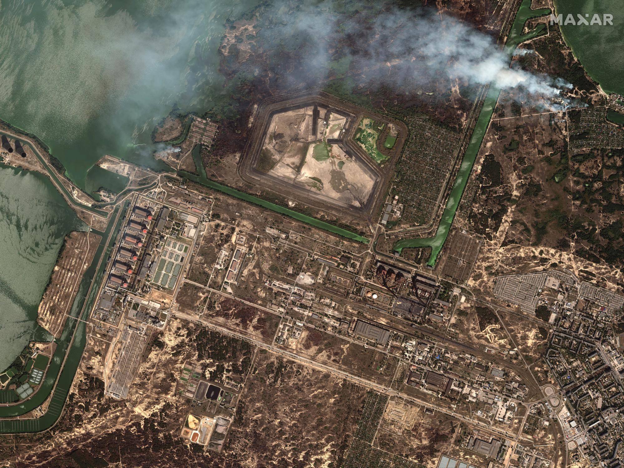 This satellite image provided by Maxar Technologies shows bush fires outside of the main power plant facilities at the Zaporizhzhia nuclear plant in Russian occupied Ukraine, Monday Aug. 29, 2022. (Satellite image ©2022 Maxar Technologies via AP)