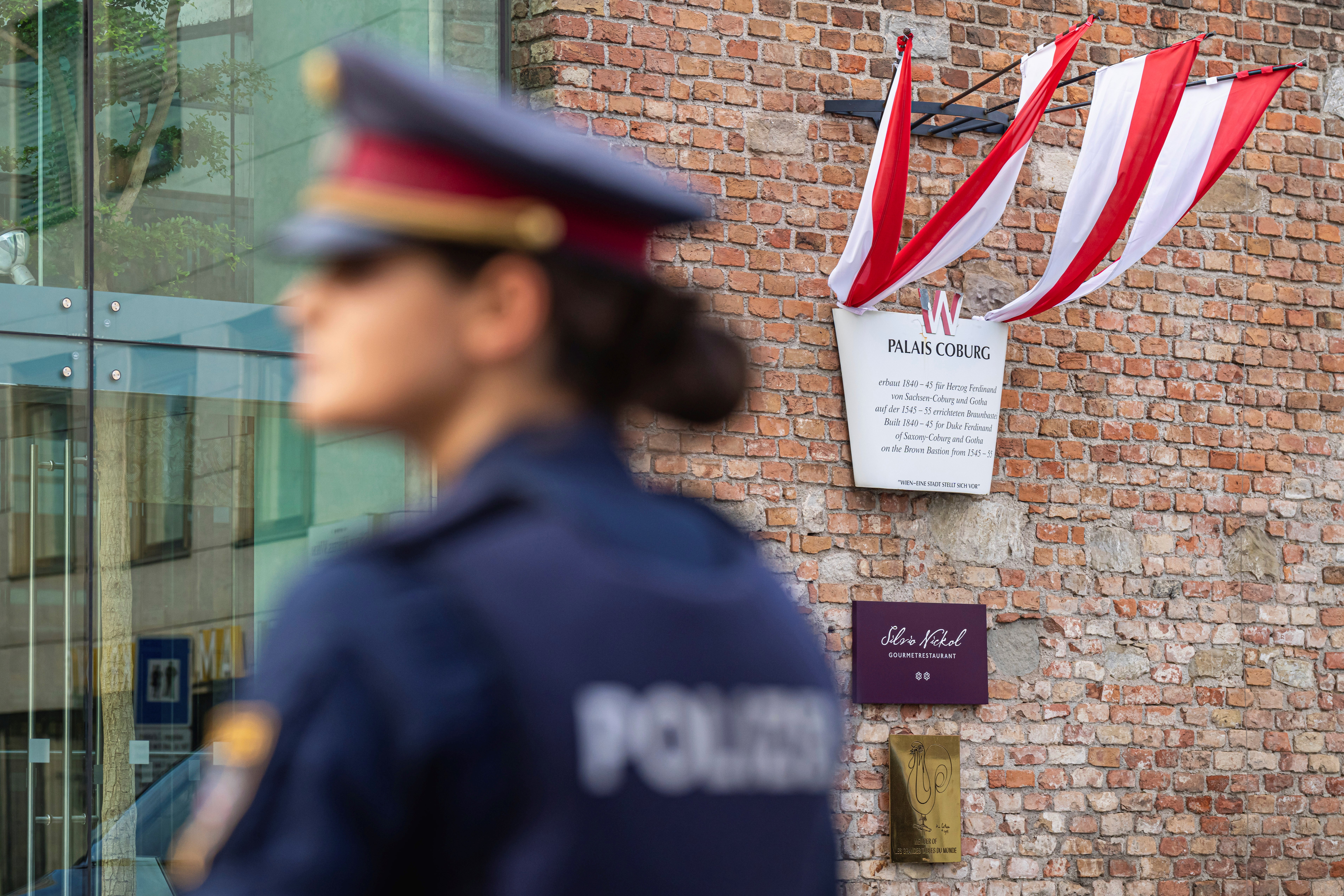 A police officer stands in front of the Palais Coburg where closed-door nuclear talks take place in Vienna, Austria, Friday, August 5, 2022 (AP Photo/Florian Schroetter)