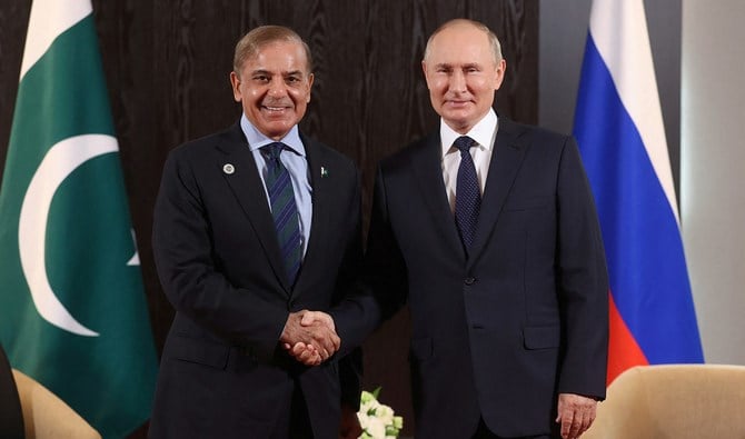 Russian President Vladimir Putin shakes hands with Pakistani Prime Minister Shehbaz Sharif during a meeting on the sidelines of the Shanghai Cooperation Organization (SCO) summit in Samarkand, Uzbekistan September 15, 2022. (Pool via REUTERS)