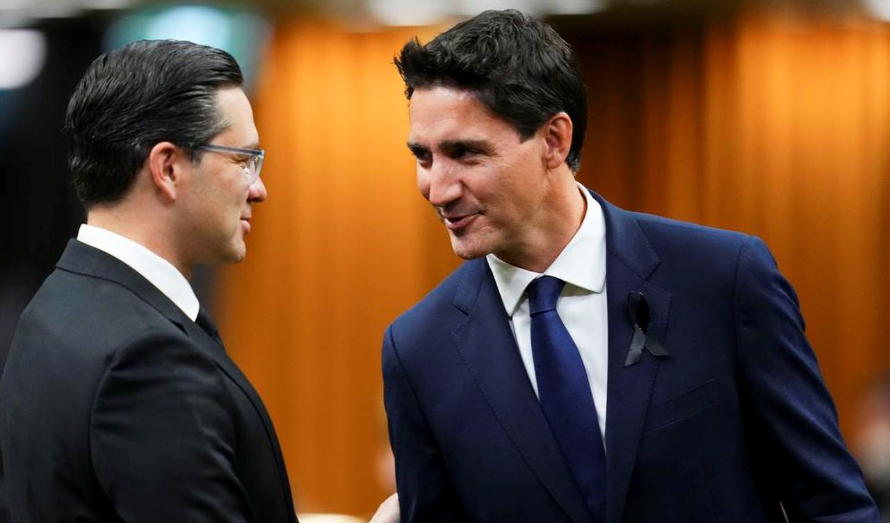 Prime Mnister Justin Trudeau and Liberal Party leader shaking hands with Conservative Party leader Pierre Poilievre after they both support both support the Bank of Canada’s restrictive monetary policy (The Canadian Press)