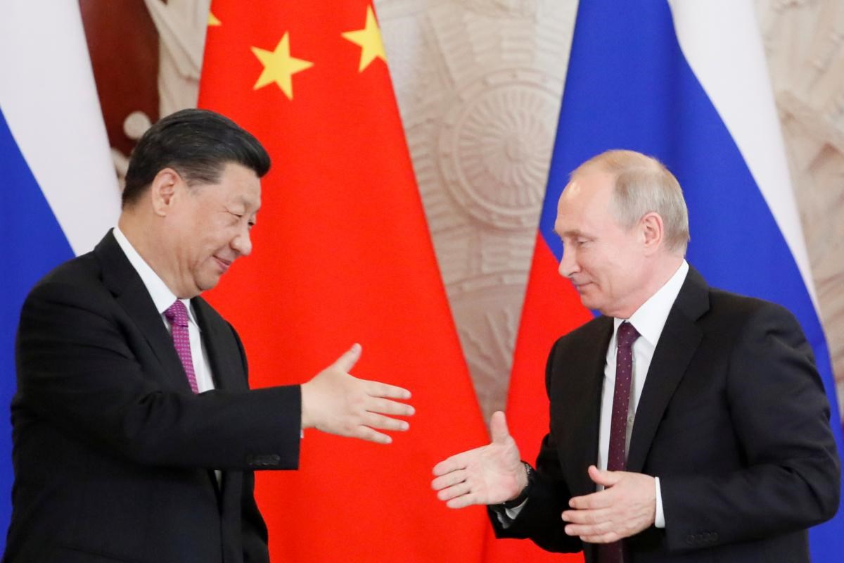 Russian President Vladimir Putin and China’s President Xi Jinping shake hands at a meeting in June 2019 Evgenia (Novozhenina / Reuters)