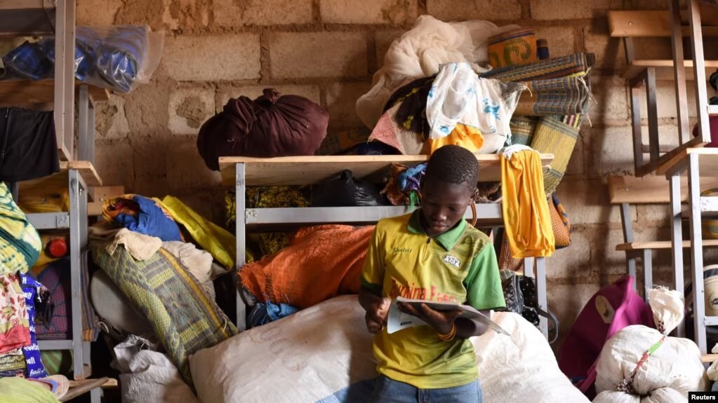 A displaced boy, who fled with others from his village in northern Burkina Faso following attacks by assailants, poses at a school on the outskirts of Ouagadougou, Burkina Faso, on June 15, 2019. (Reuters)