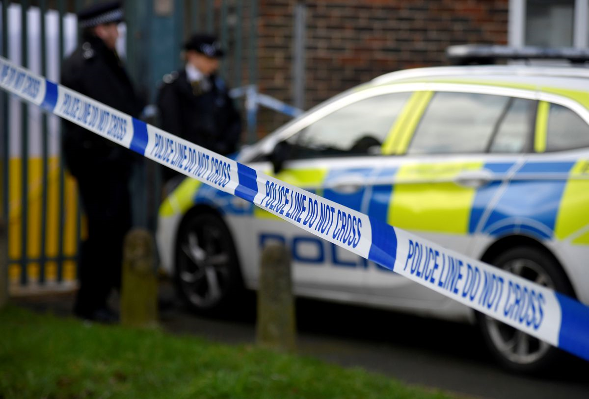 UK Police officers stand outside closed off scene (Reuters)