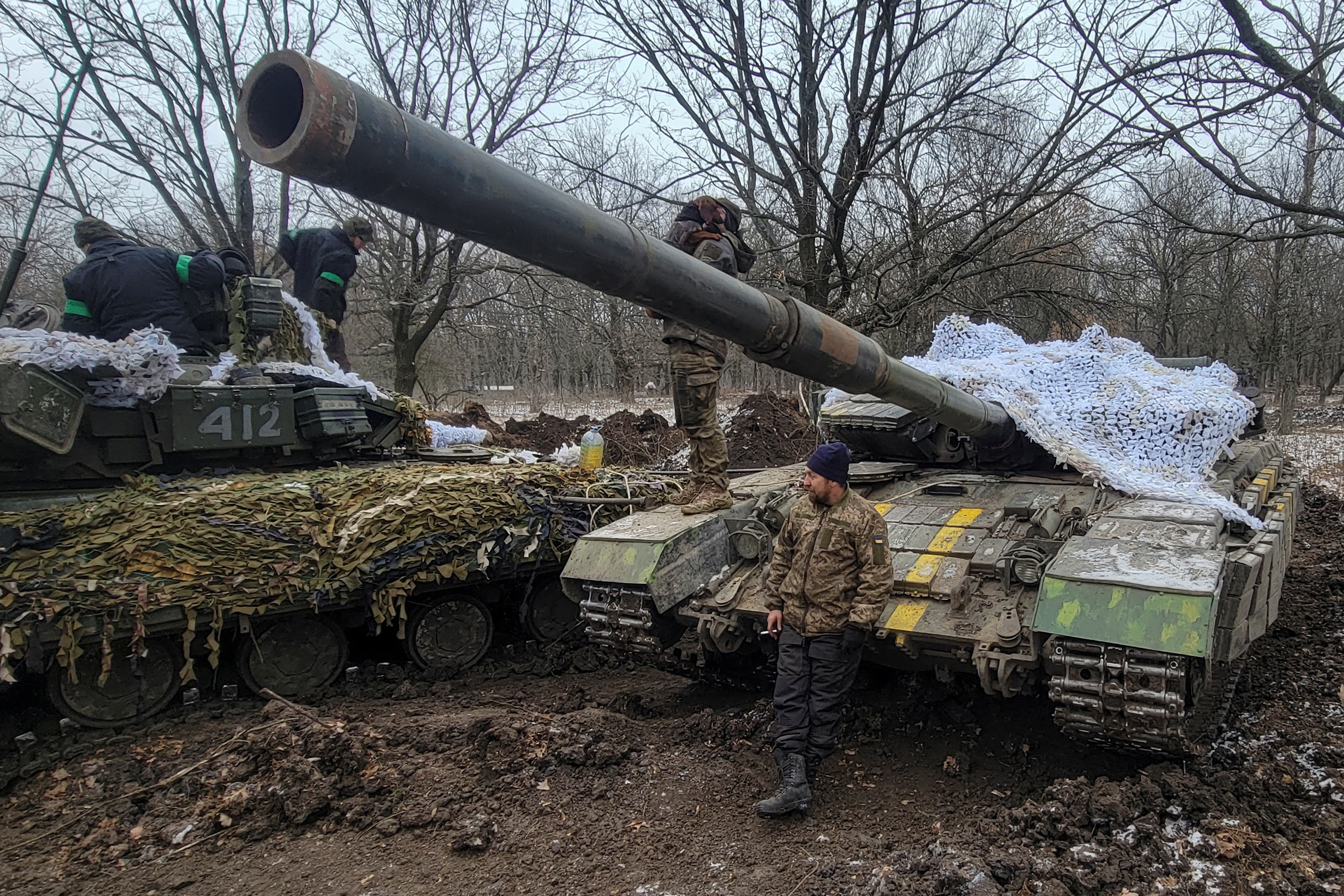 Ukrainian servicemen stand on their tanks near the frontline town of Bakhmut, amid Russia's attack on Ukraine, in Donetsk region, Ukraine January 13, 2023 (Reuters).