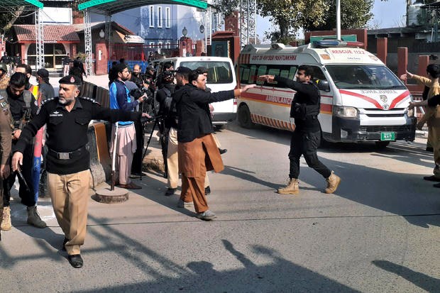 Police officers clear the way for ambulances carrying wounding people from the scene of a bomb explosion at a mosque in Peshawar, Pakistan, January 30, 2023.(AP)