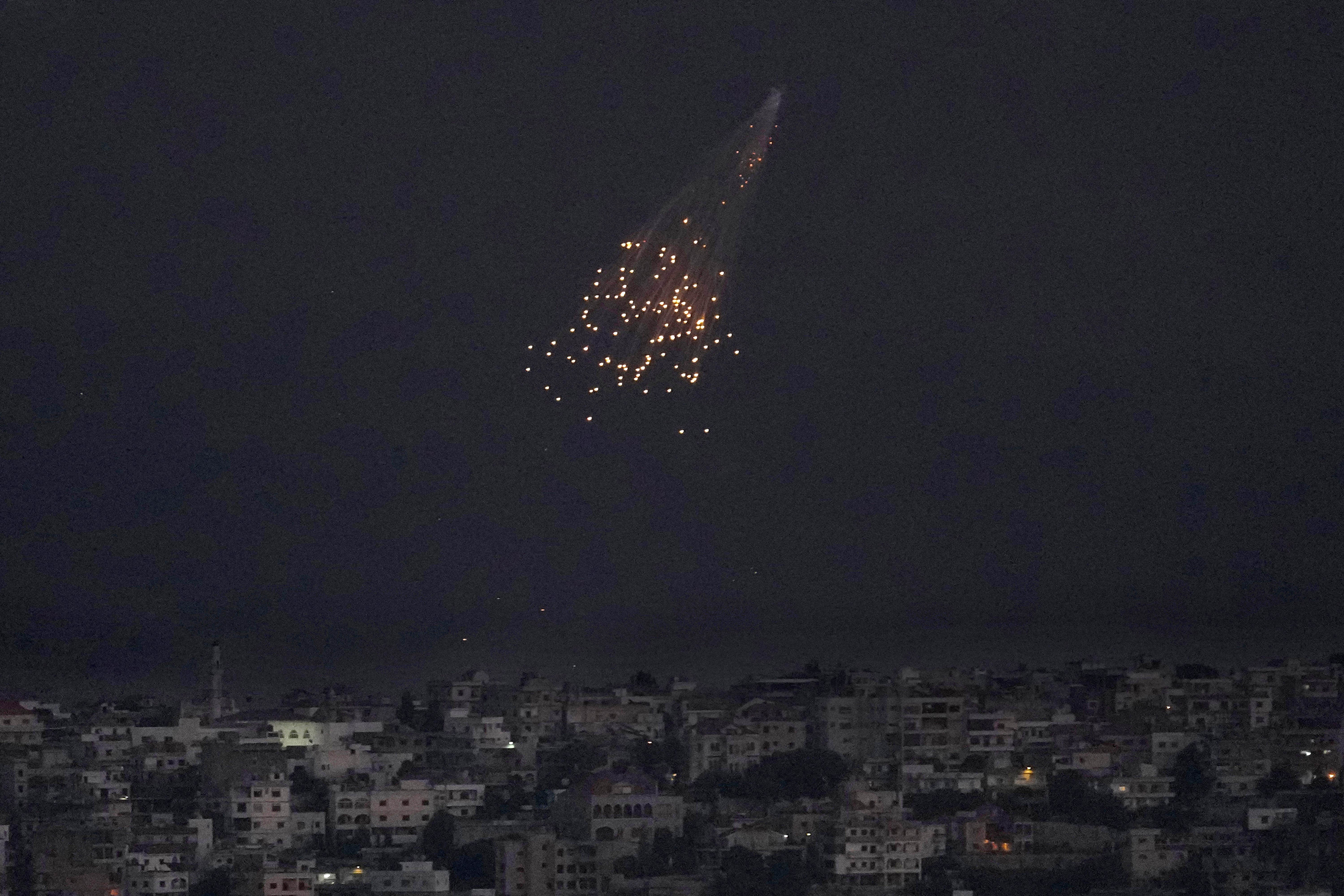 A shell from Israeli artillery explodes over Bastra Farms in the occupied Shebaa Farms, south Lebanon, Tuesday, Oct. 10, 2023 (AP)