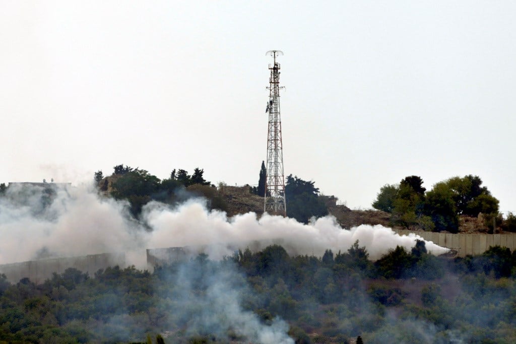 Smoke rises after Israeli shelling near an Israeli military position, background, in the village of Duhaira near the border area, south Lebanon, Wednesday, Oct. 11, 2023 (AP Photo/Hassan Ammar)